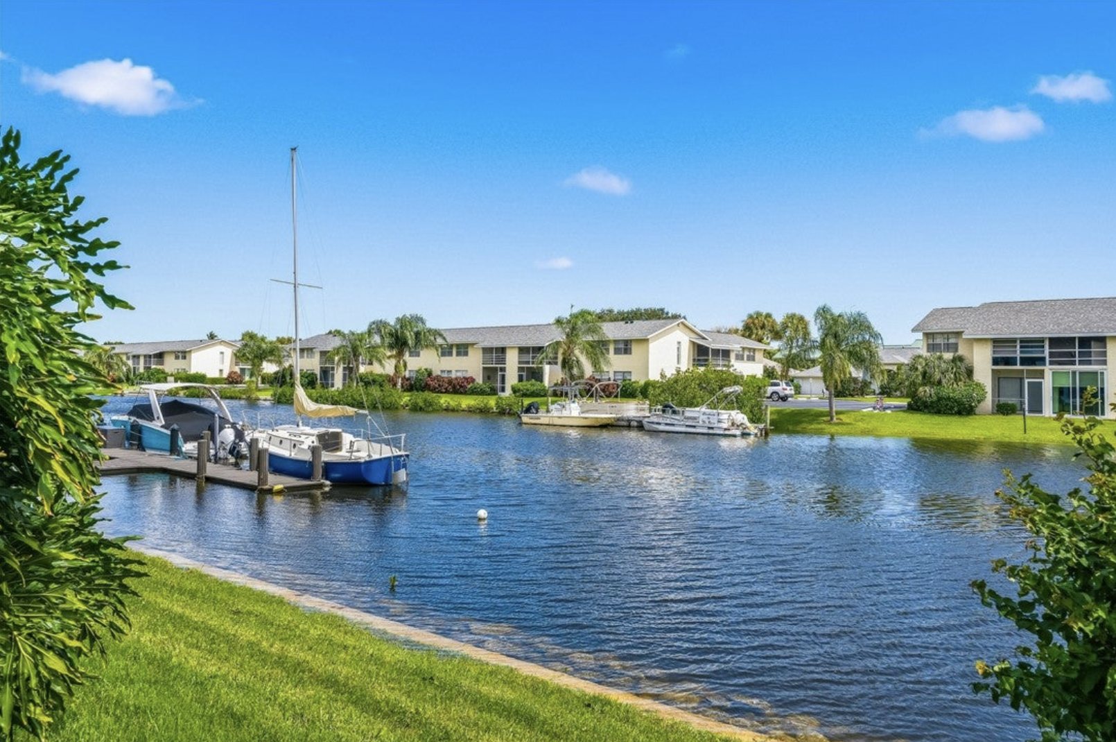1830 Robalo Drive Unit B103, Vero Beach — Canal-front exterior with docked boats (photo 1)